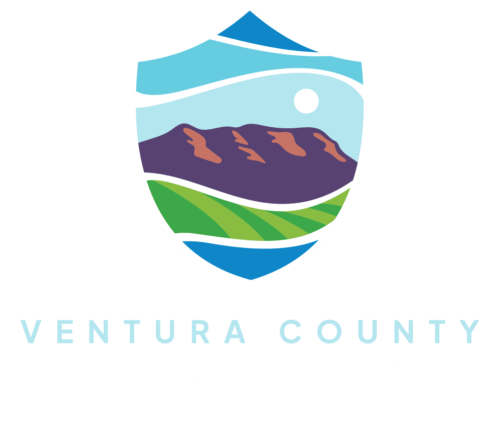 Logo of Ventura County Air Pollution Control District featuring a shield with a mountain, fields, sky, and sun.
